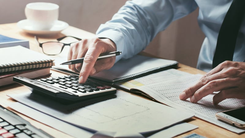 An accountant going through accounting and finance documents.